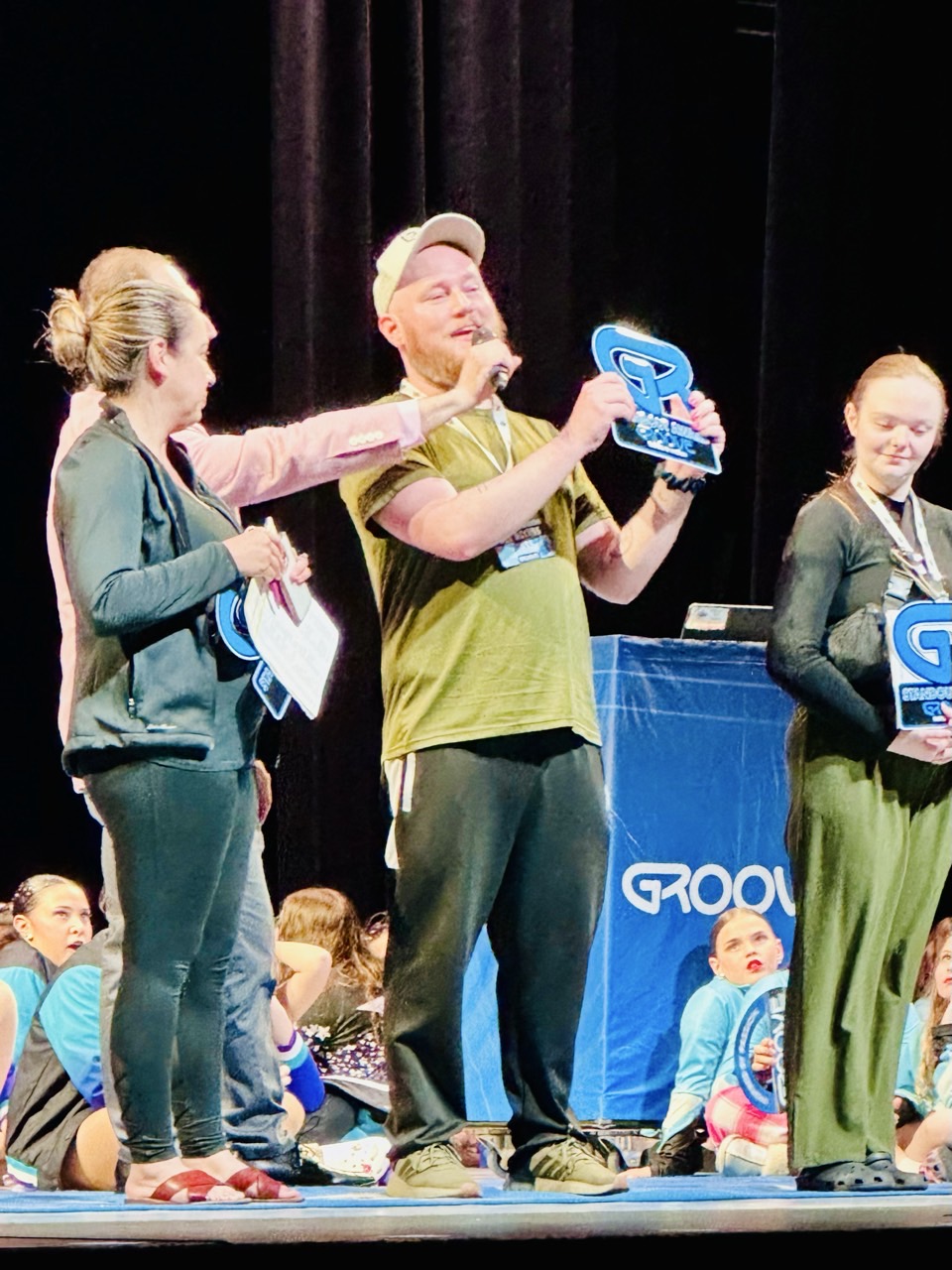 Dixon commanding the stage at GROOVE with award plaque