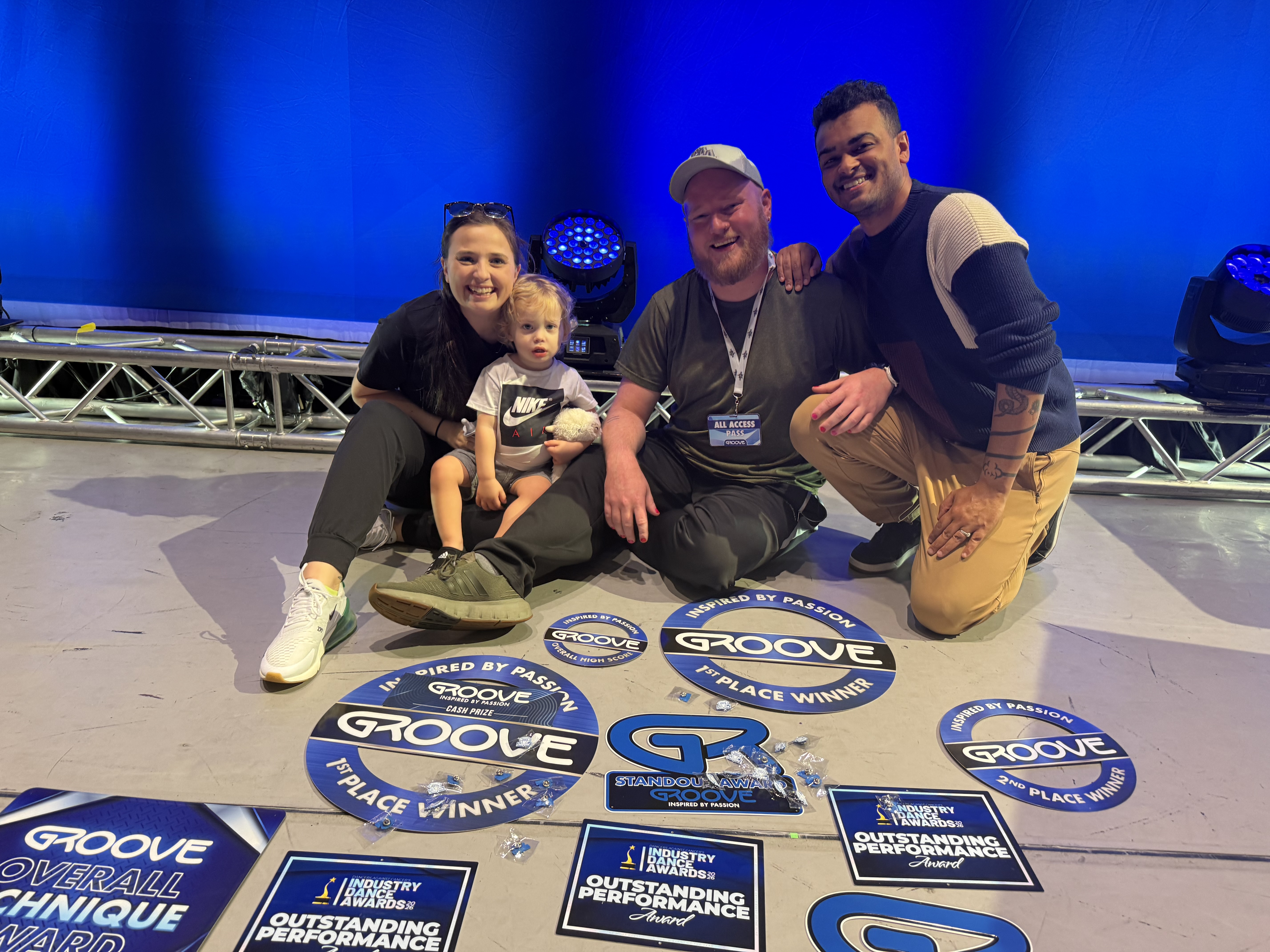 Dixon and Malik on GROOVE stage surrounded by awards