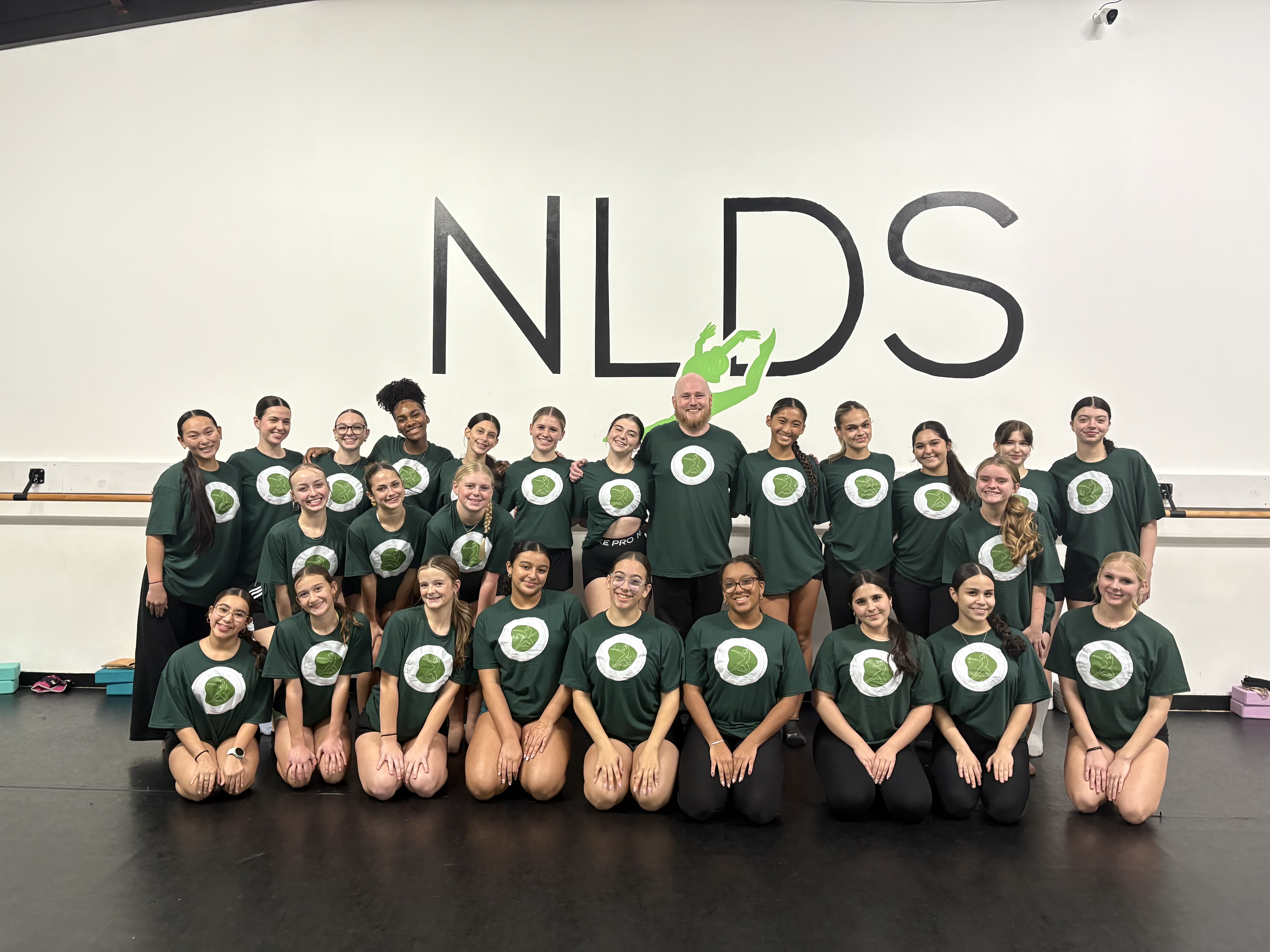 Dixon with NLDS class in matching green shirts