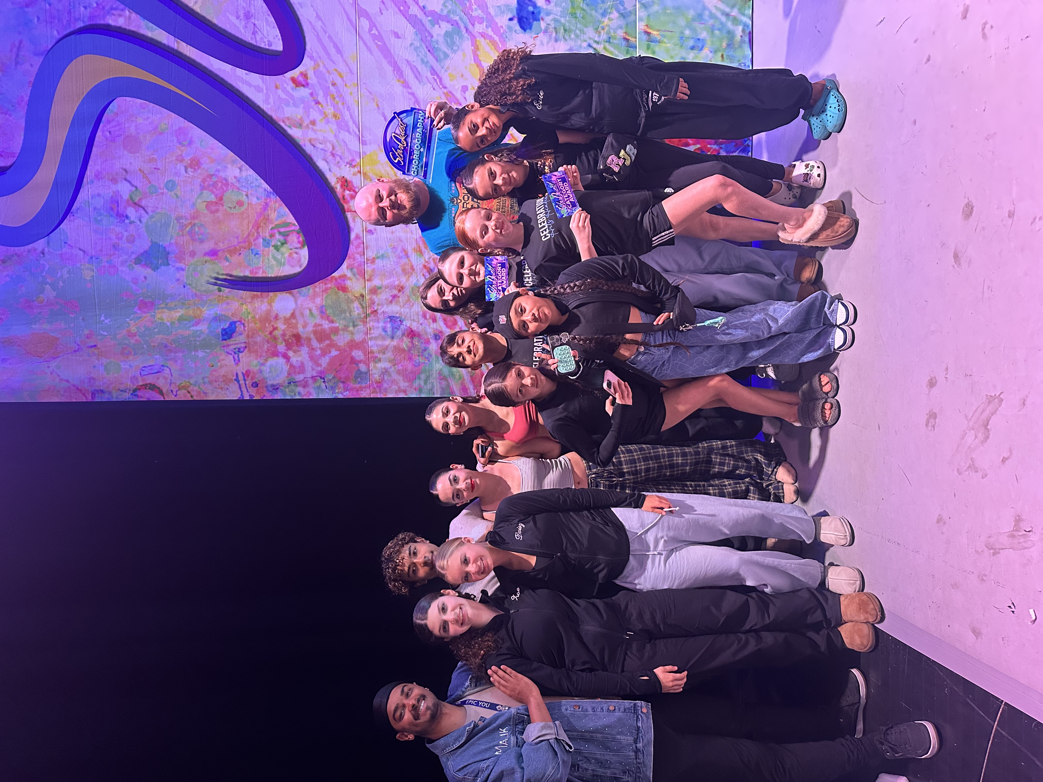 Dixon with team on stage celebrating at competition