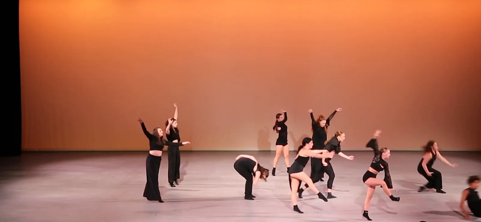 The ensemble mid-phrase against the amber cyc