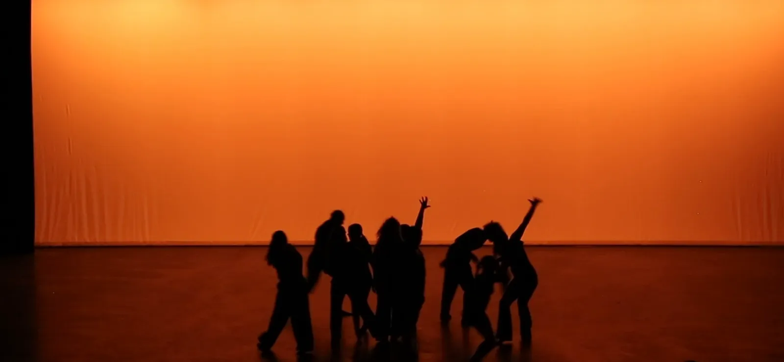Dancers in silhouette as the lights drop