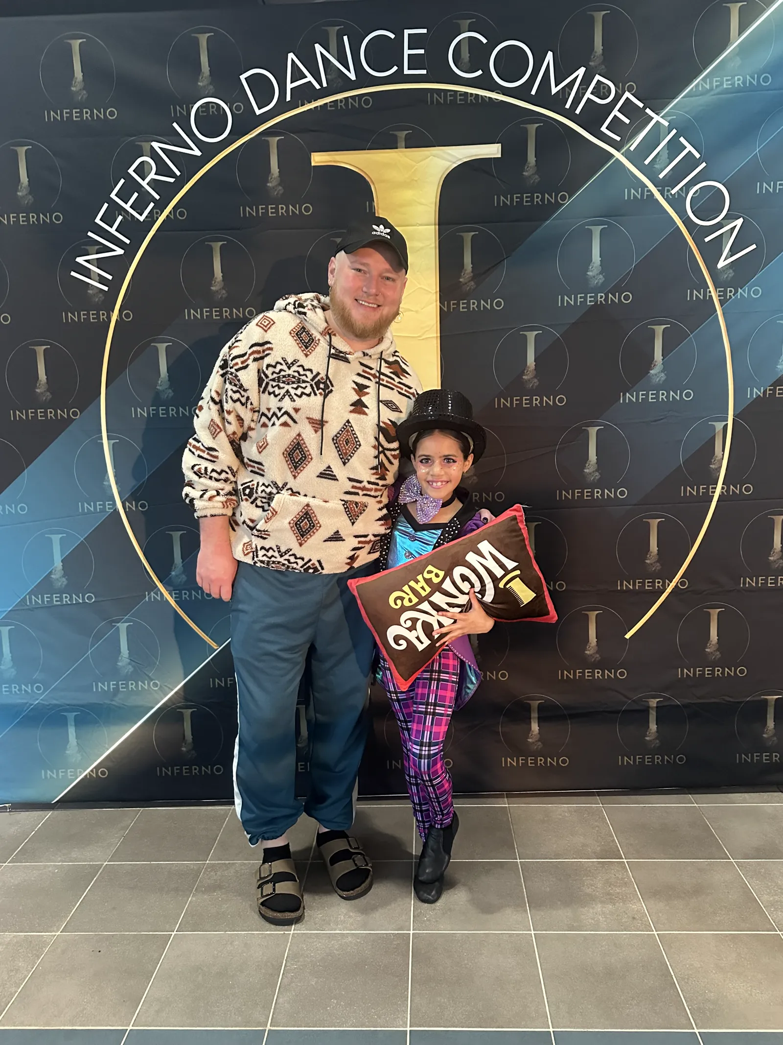 Dixon holding ADCC Studio of Excellence Winner banner