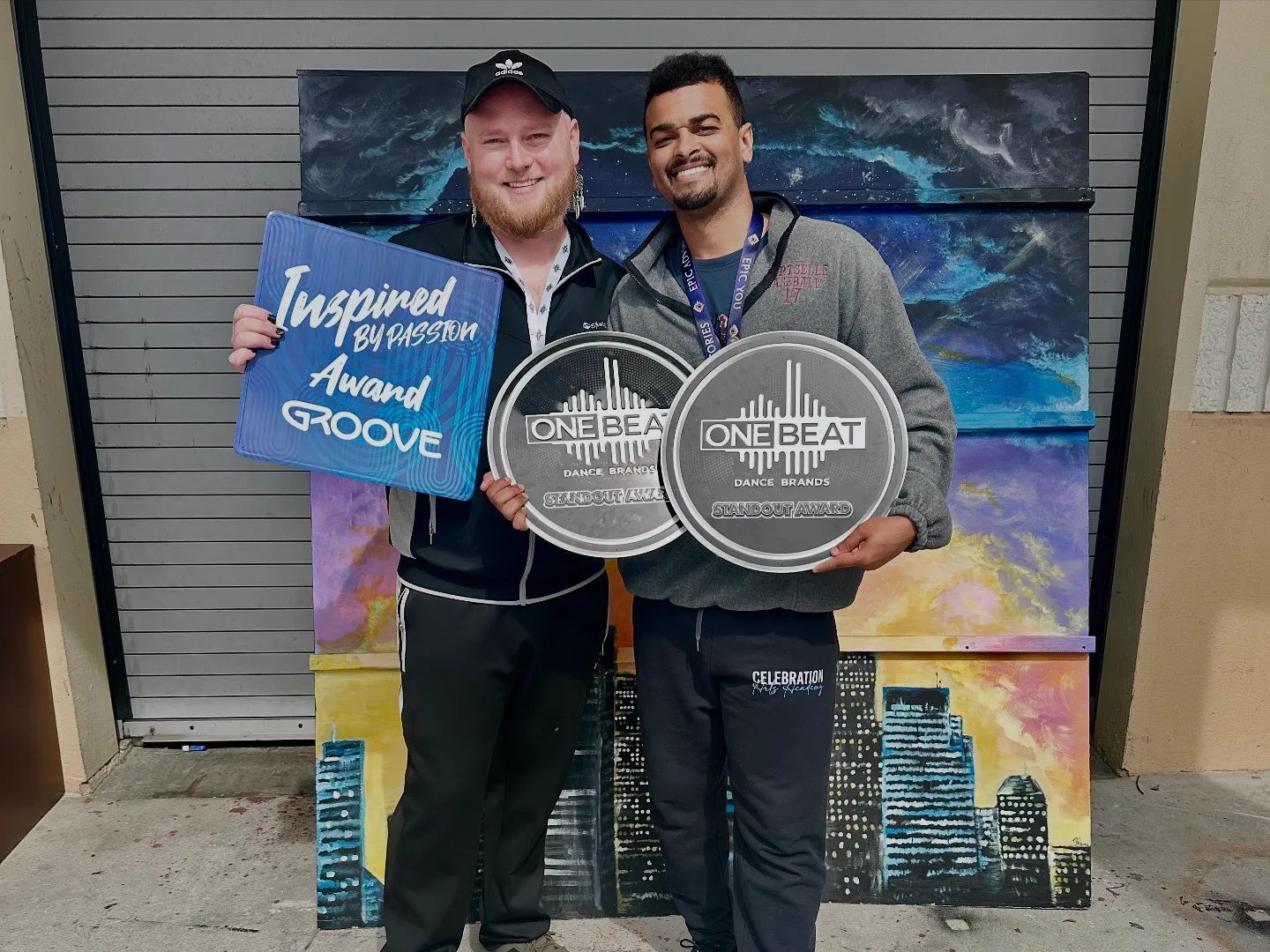 Dixon and Malik holding GROOVE and One Beat trophies